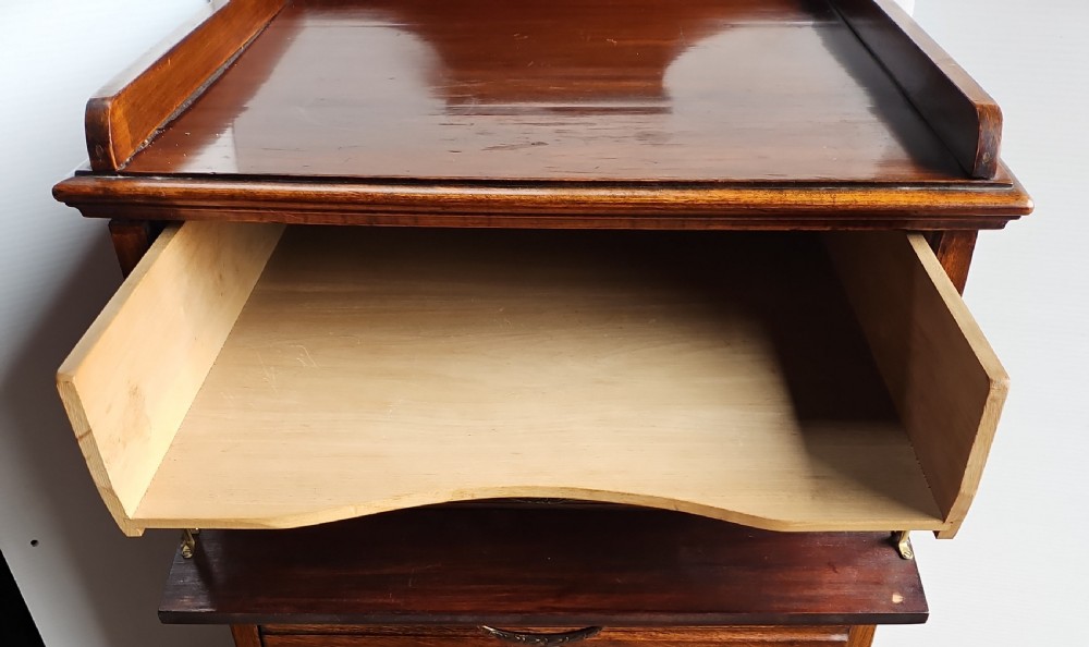 A tall mahogany sheet music cabinet featuring seven drawers with brass drop handles and a gallery top. View VII