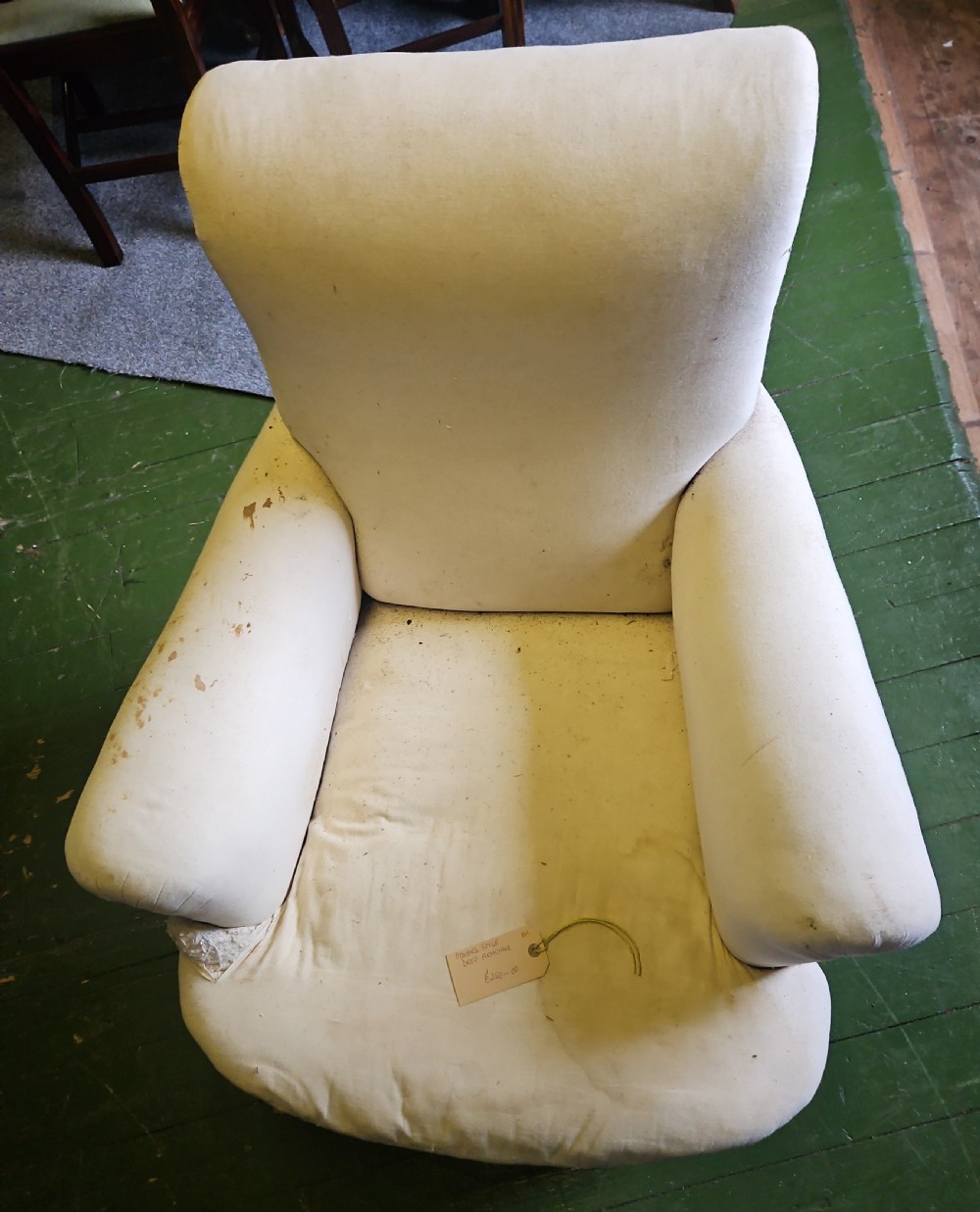 A deep-seated Howard style armchair upholstered in off-white calico fabric with low padded arms. View III
