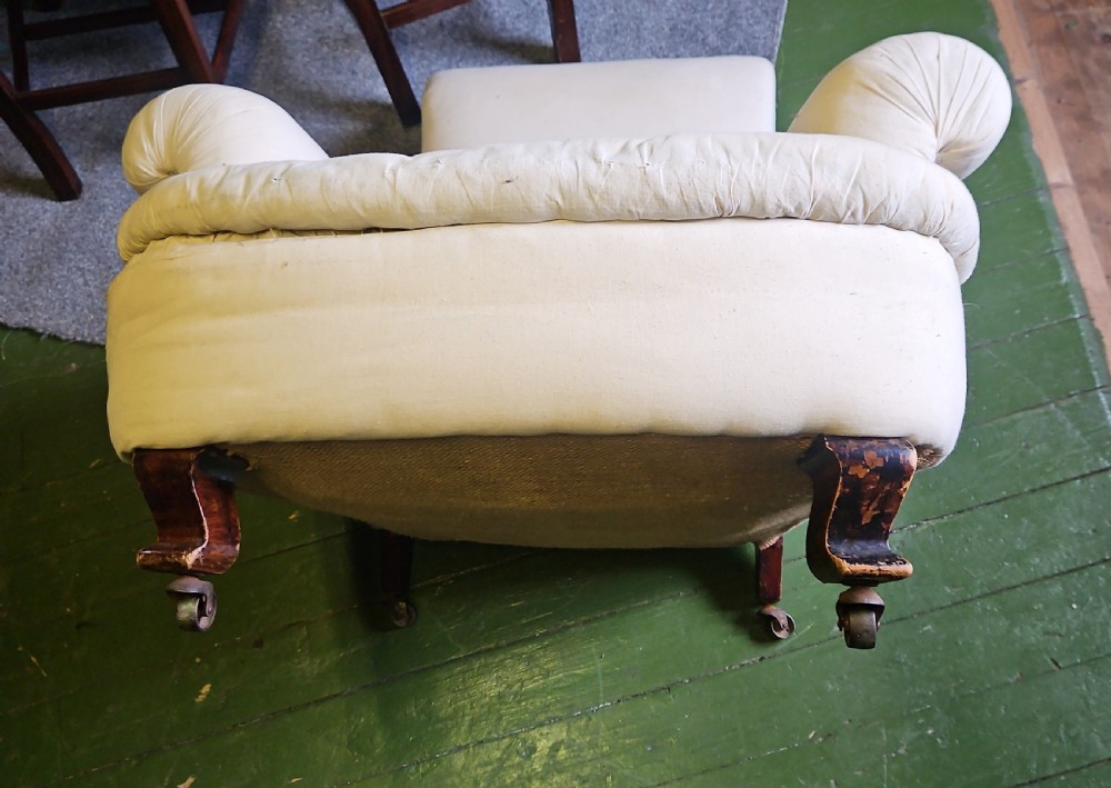 A deep-seated Howard style armchair upholstered in off-white calico fabric with low padded arms. View IV