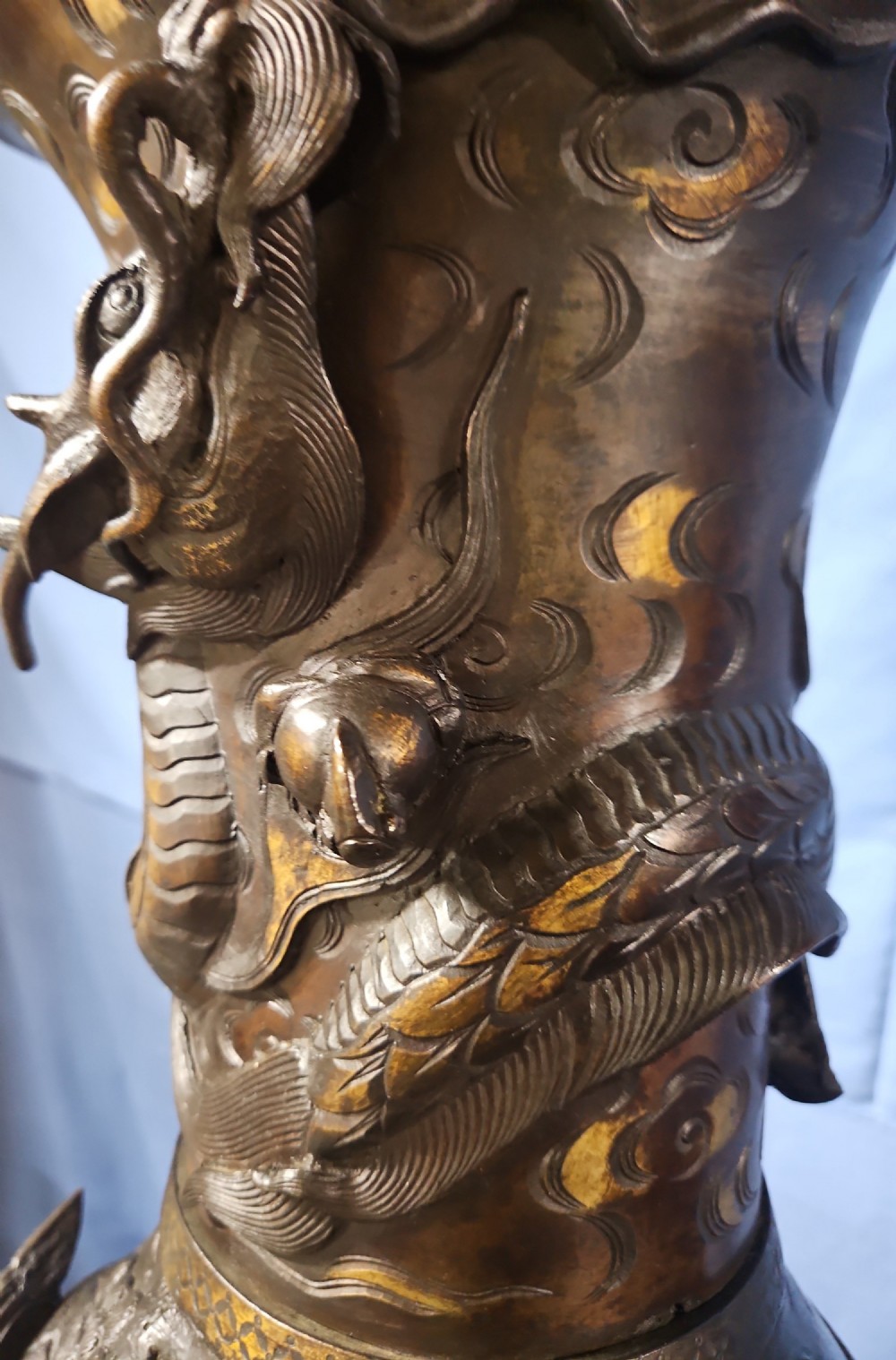 A pair of large Japanese bronze vases featuring high-relief sculpted dragons around the necks and crane motifs on bulbous bases with gilt detailing. View II