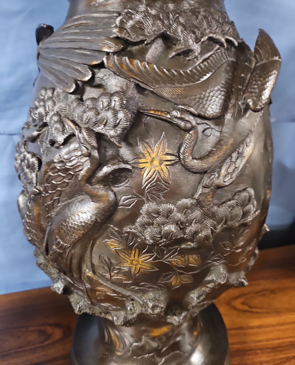 A pair of large Japanese bronze vases featuring high-relief sculpted dragons around the necks and crane motifs on bulbous bases with gilt detailing. View IV