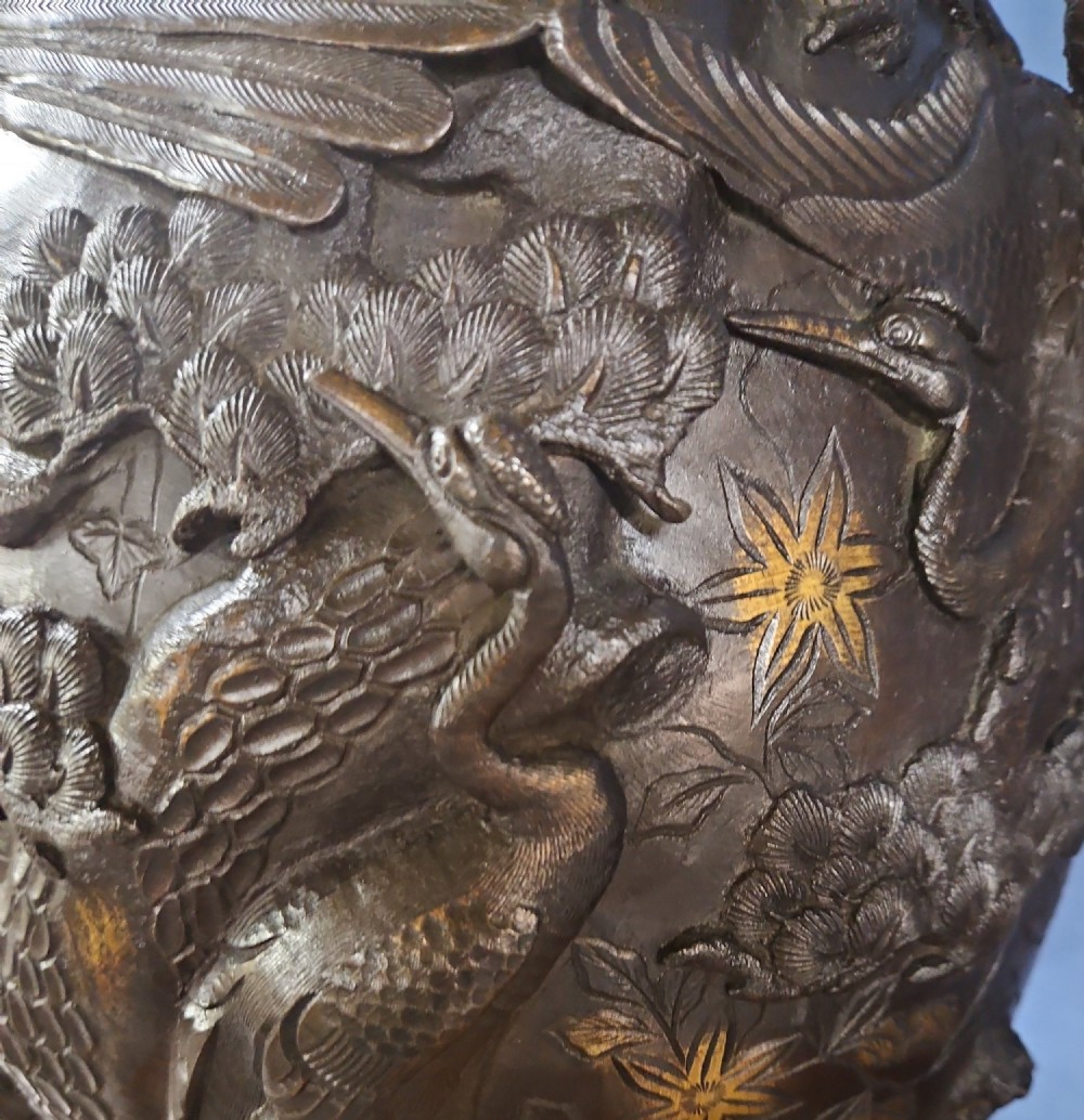 A pair of large Japanese bronze vases featuring high-relief sculpted dragons around the necks and crane motifs on bulbous bases with gilt detailing. View VII