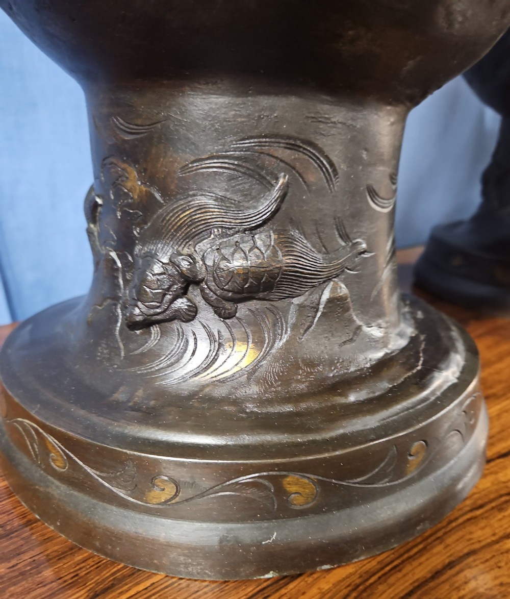 A pair of large Japanese bronze vases featuring high-relief sculpted dragons around the necks and crane motifs on bulbous bases with gilt detailing. View VIII