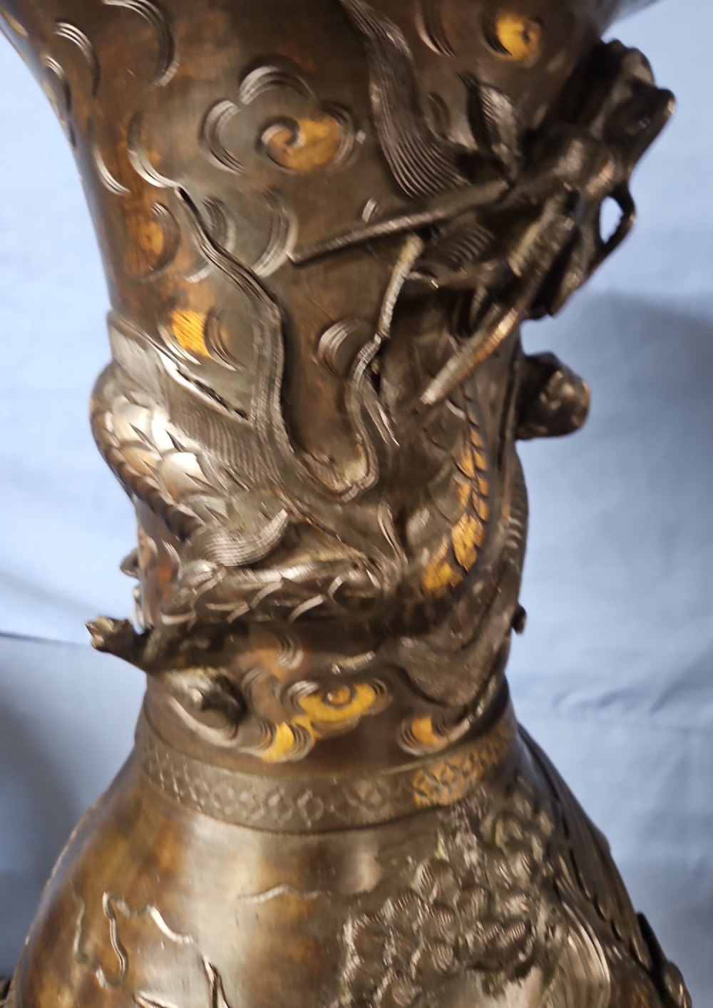 A pair of large Japanese bronze vases featuring high-relief sculpted dragons around the necks and crane motifs on bulbous bases with gilt detailing. View IX