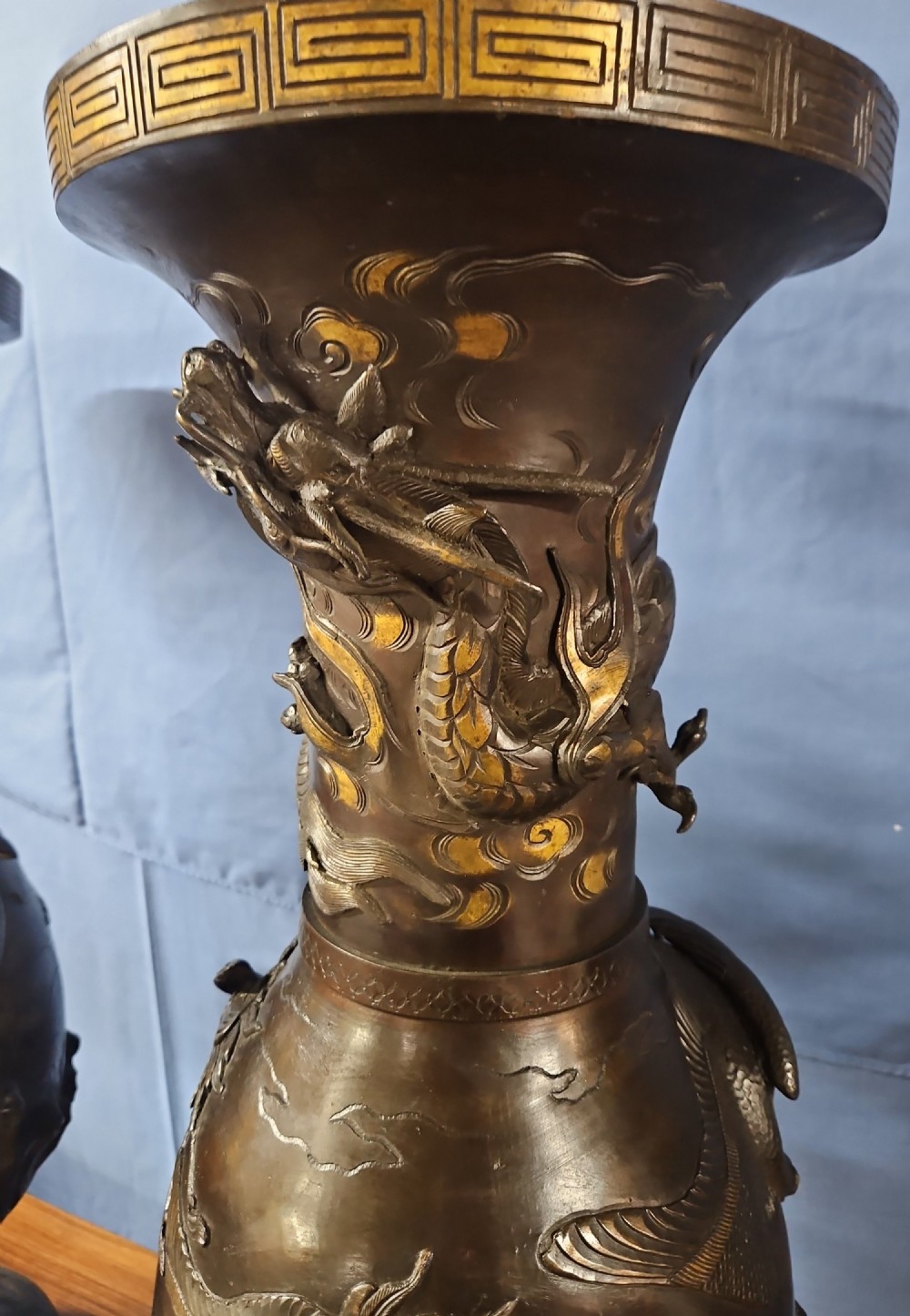 A pair of large Japanese bronze vases featuring high-relief sculpted dragons around the necks and crane motifs on bulbous bases with gilt detailing. View XIII