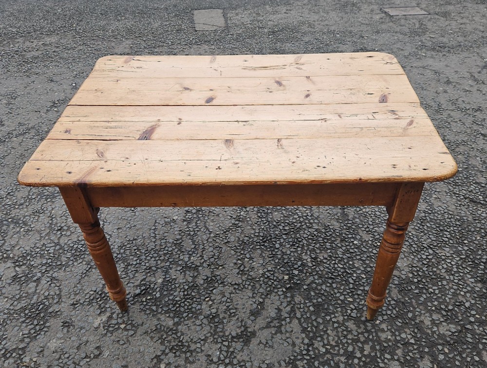 A rectangular Victorian pine table featuring a multi-plank top with visible grain patterns and four turned wooden legs. View III