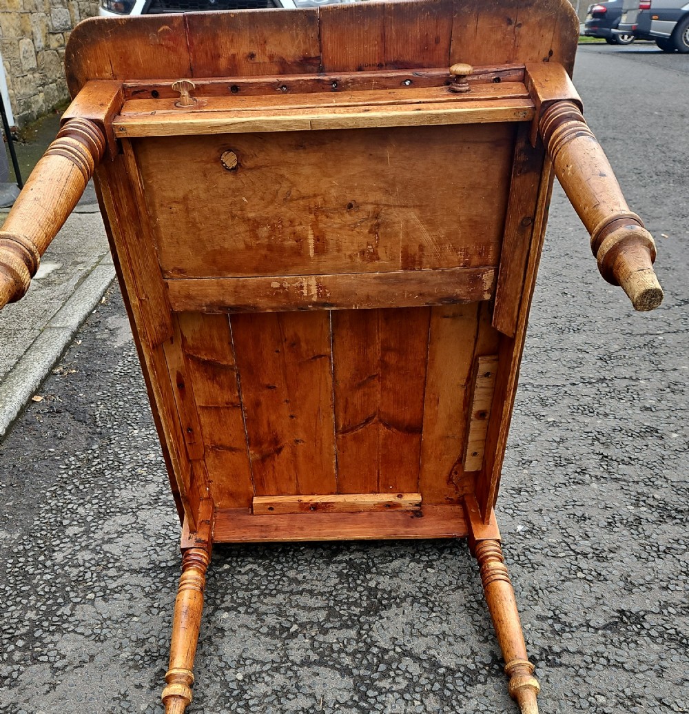 A rectangular Victorian pine table featuring a multi-plank top with visible grain patterns and four turned wooden legs. View IX