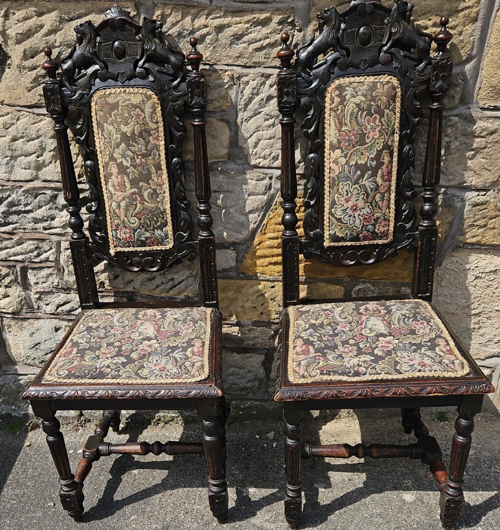 A pair of Victorian carved oak chairs