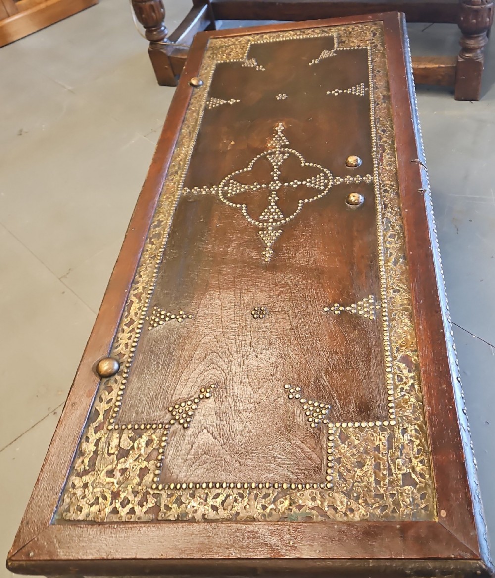 A mid-Victorian wooden Zanzibar chest decorated with intricate brass studs, geometric brass sheeting, and three base drawers. View III