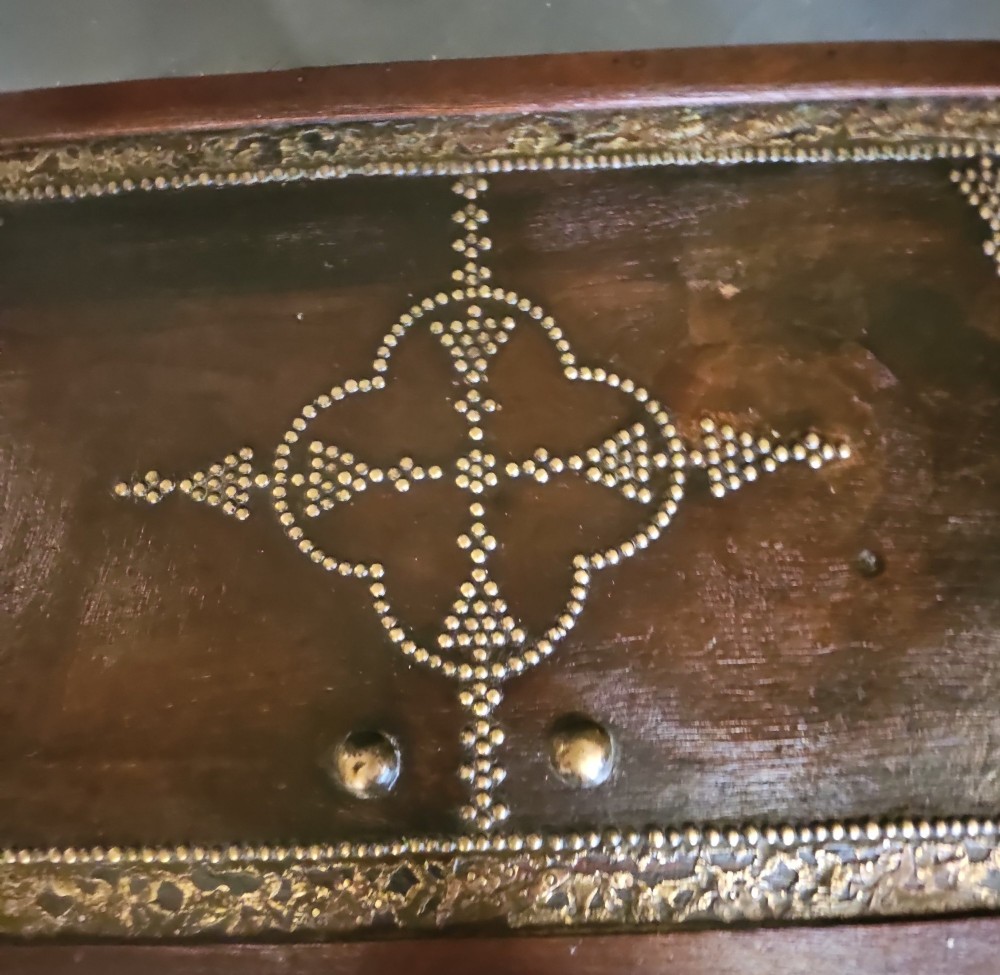 A mid-Victorian wooden Zanzibar chest decorated with intricate brass studs, geometric brass sheeting, and three base drawers. View XIII