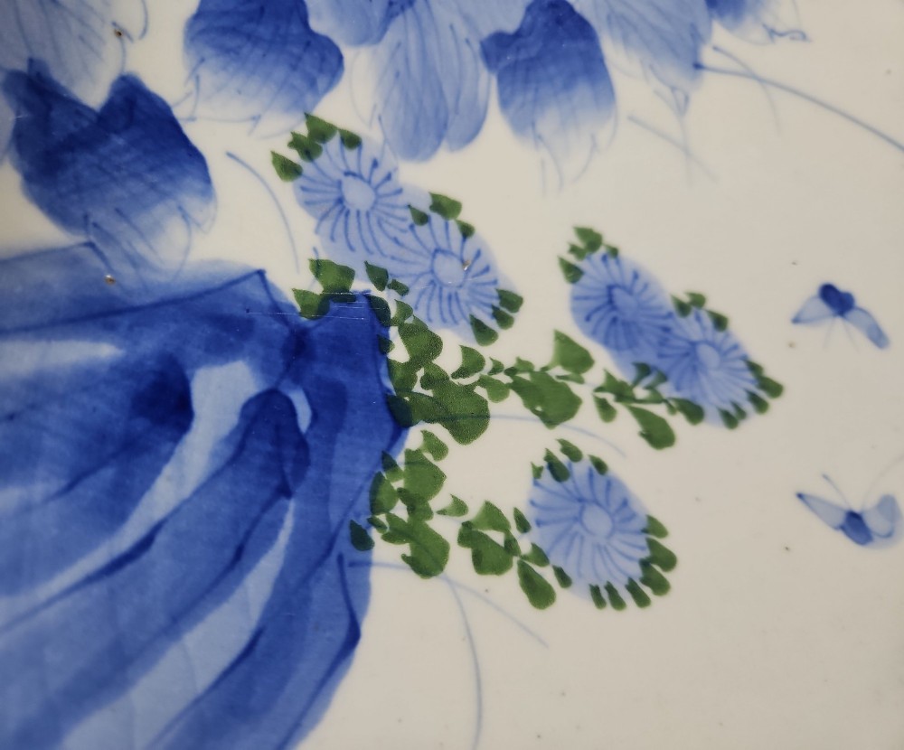 A circular blue and white Japanese Arita porcelain charger decorated with a flowering prunus branch and chrysanthemum blossoms. View II