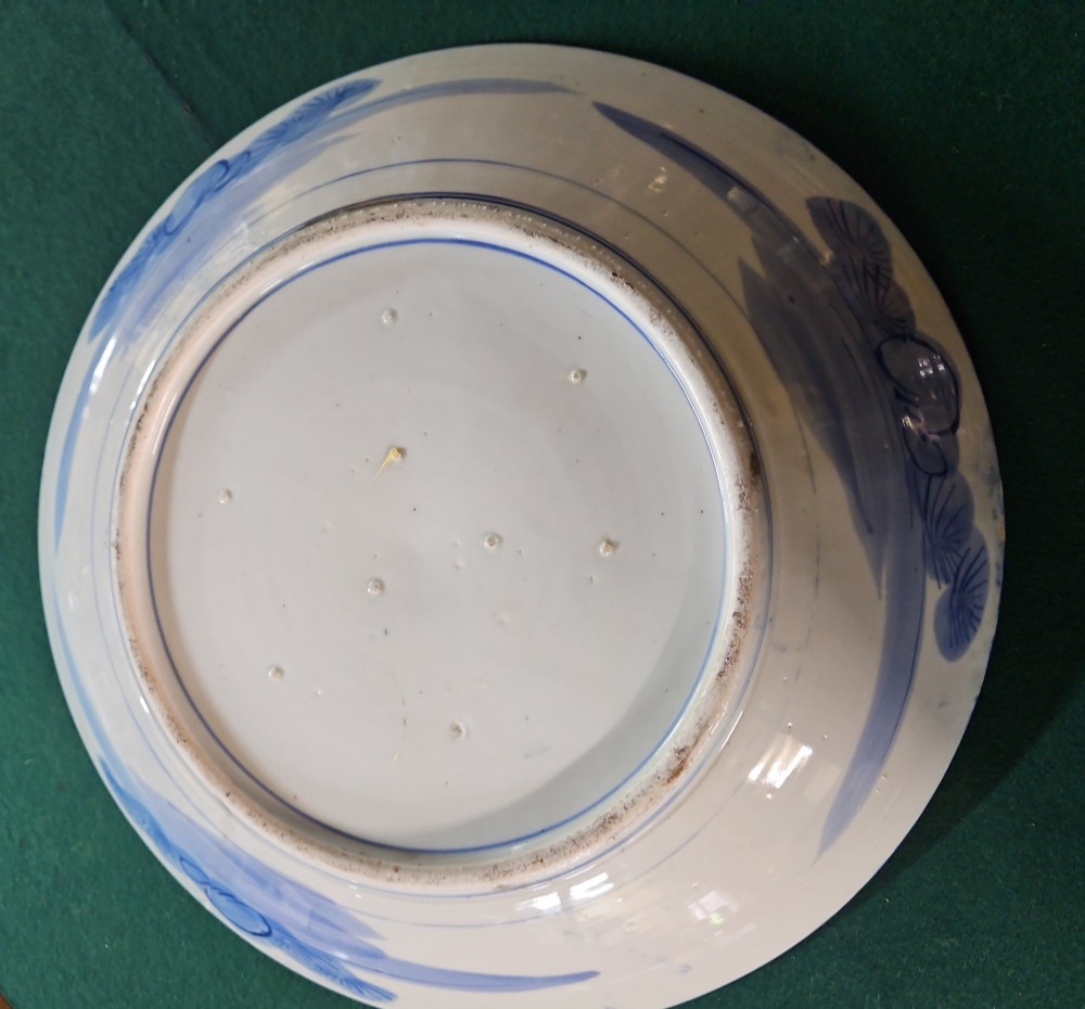 A circular blue and white Japanese Arita porcelain charger decorated with a flowering prunus branch and chrysanthemum blossoms. View V