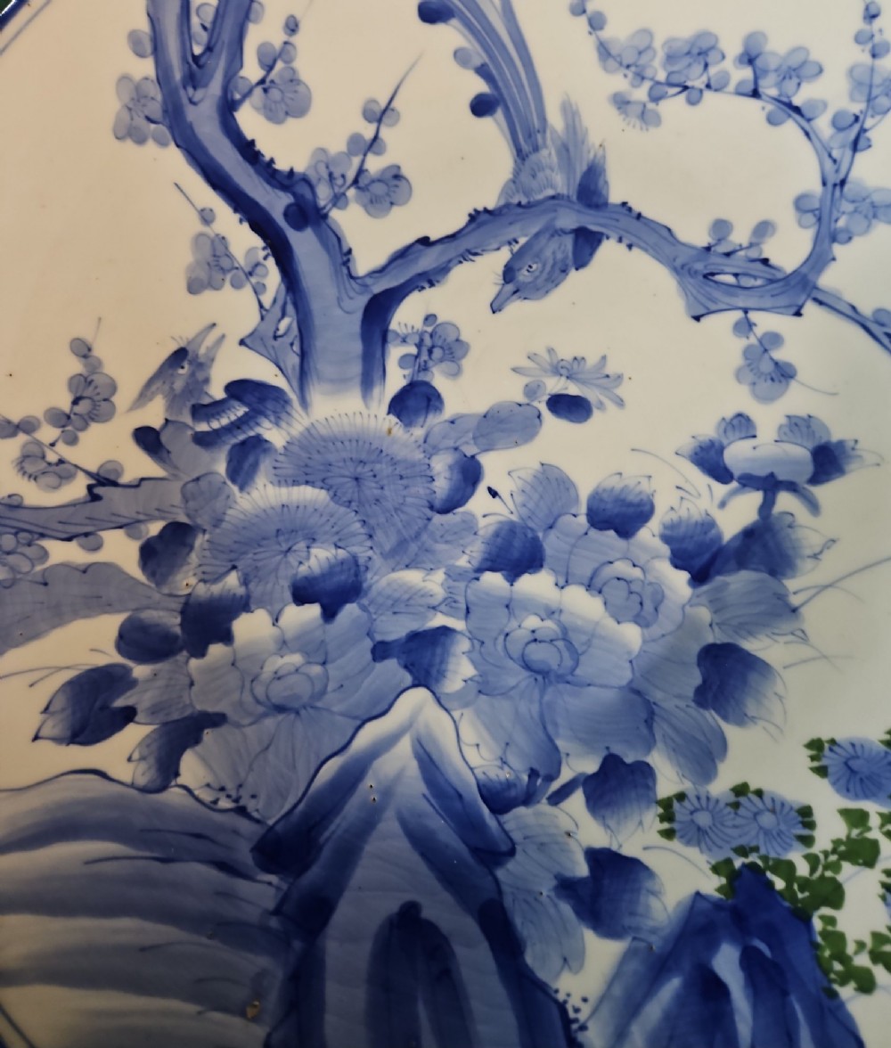 A circular blue and white Japanese Arita porcelain charger decorated with a flowering prunus branch and chrysanthemum blossoms. View VIII