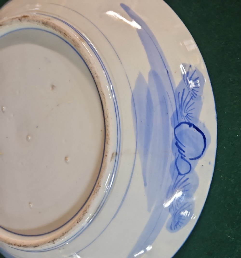 A circular blue and white Japanese Arita porcelain charger decorated with a flowering prunus branch and chrysanthemum blossoms. View IX