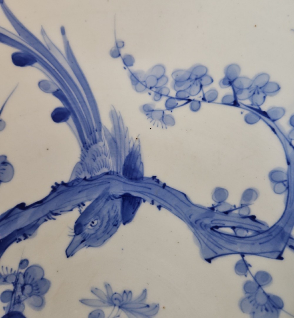 A circular blue and white Japanese Arita porcelain charger decorated with a flowering prunus branch and chrysanthemum blossoms. View XI
