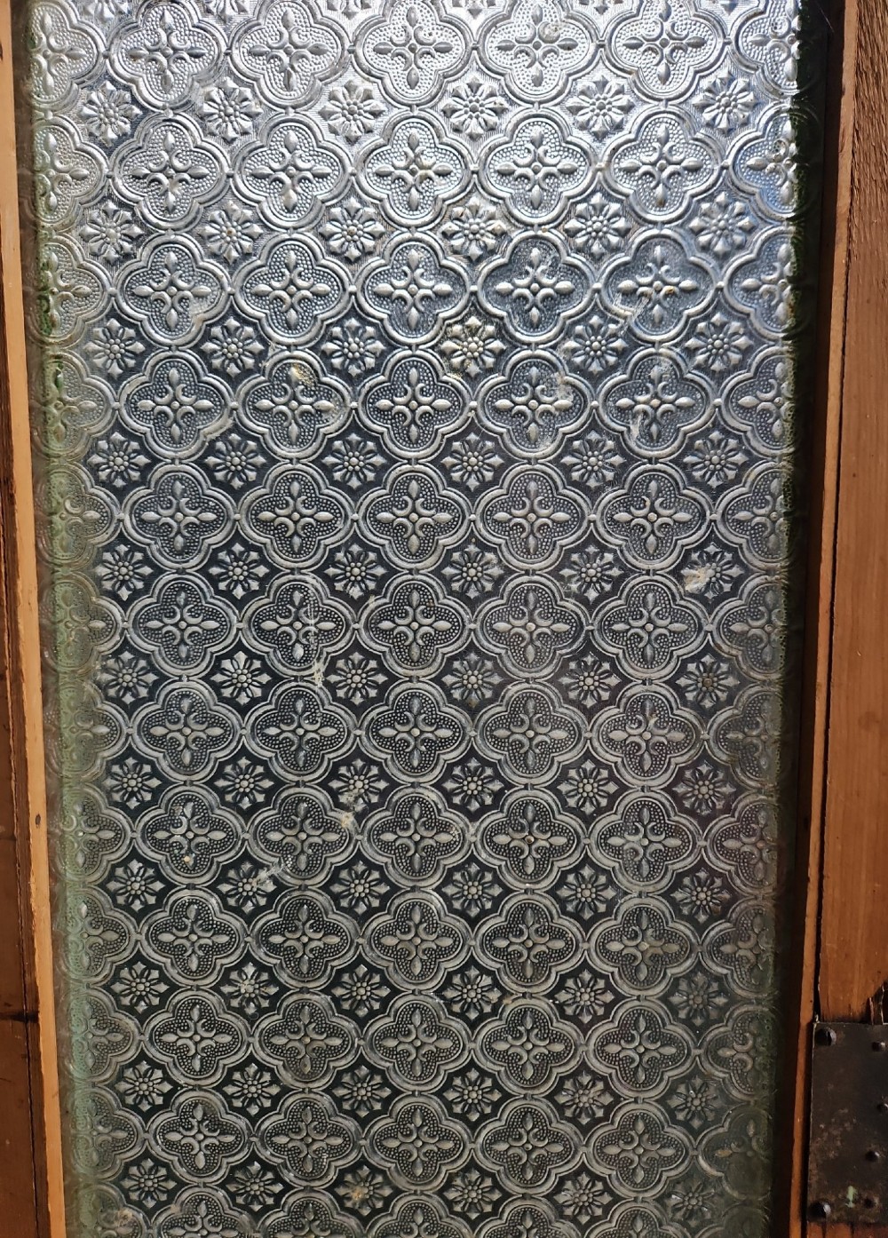 A distressed green painted pine kitchen cabinet featuring upper glazed doors, drawers, and lower panelled wooden doors. View VI