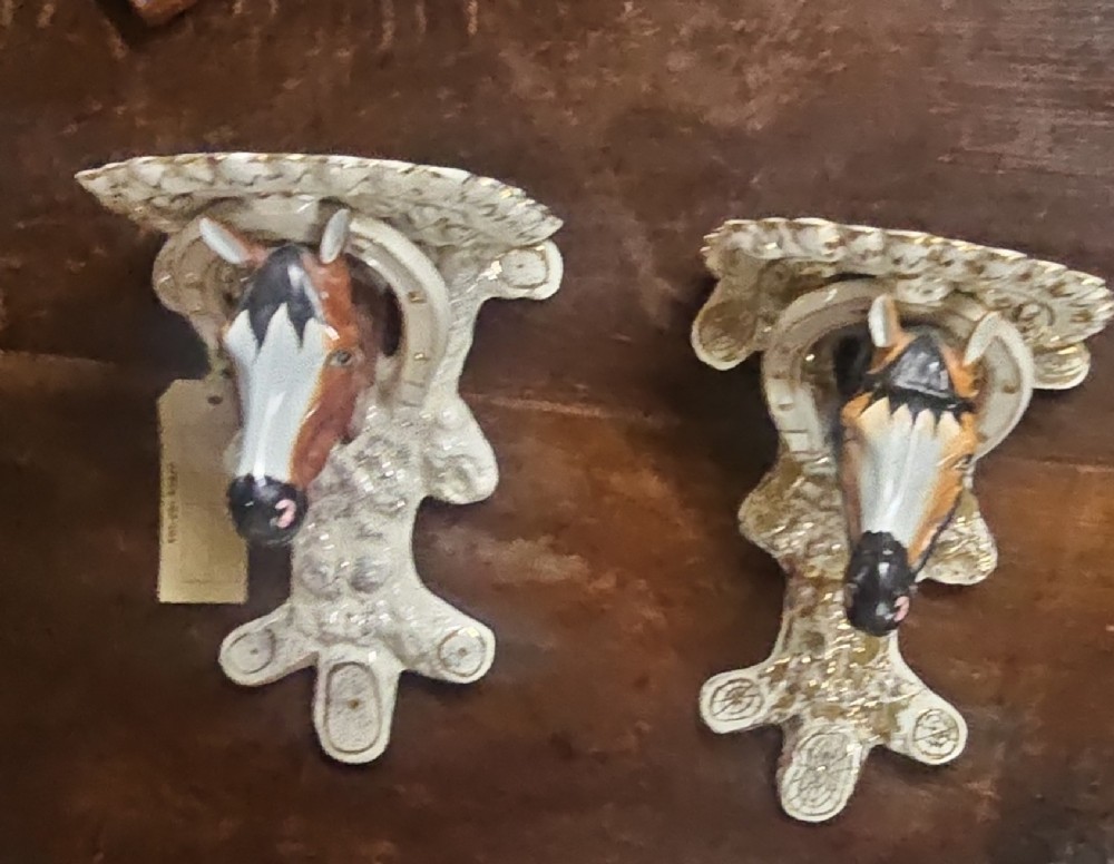 A pair of Victorian Staffordshire earthenware wall brackets featuring moulded horse heads framed by horseshoes with gilded decorative borders. View II