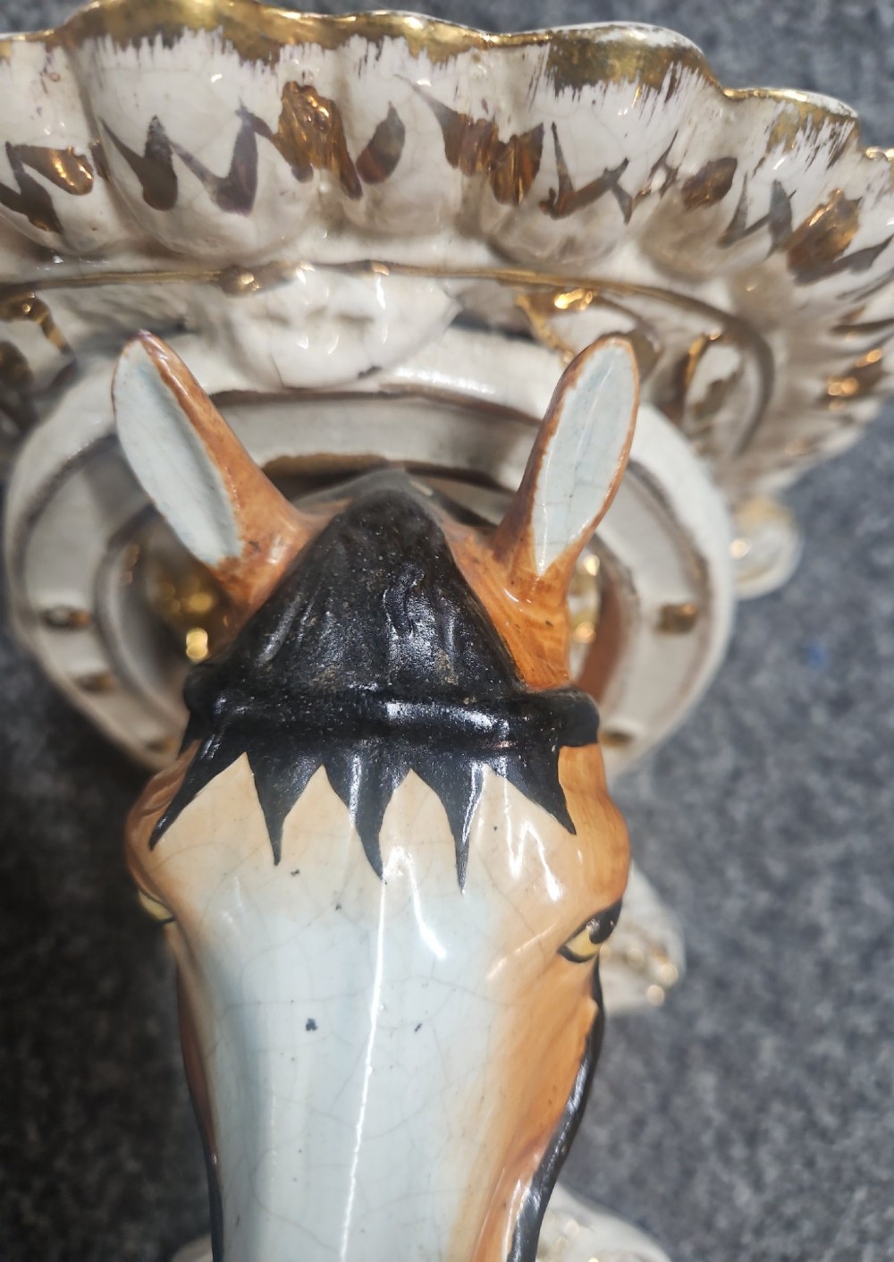 A pair of Victorian Staffordshire earthenware wall brackets featuring moulded horse heads framed by horseshoes with gilded decorative borders. View VI