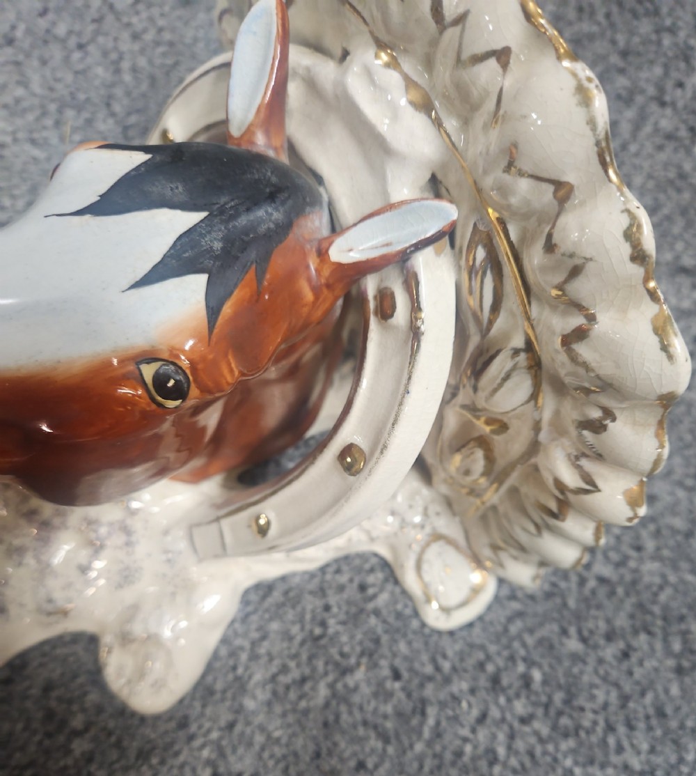 A pair of Victorian Staffordshire earthenware wall brackets featuring moulded horse heads framed by horseshoes with gilded decorative borders. View VII