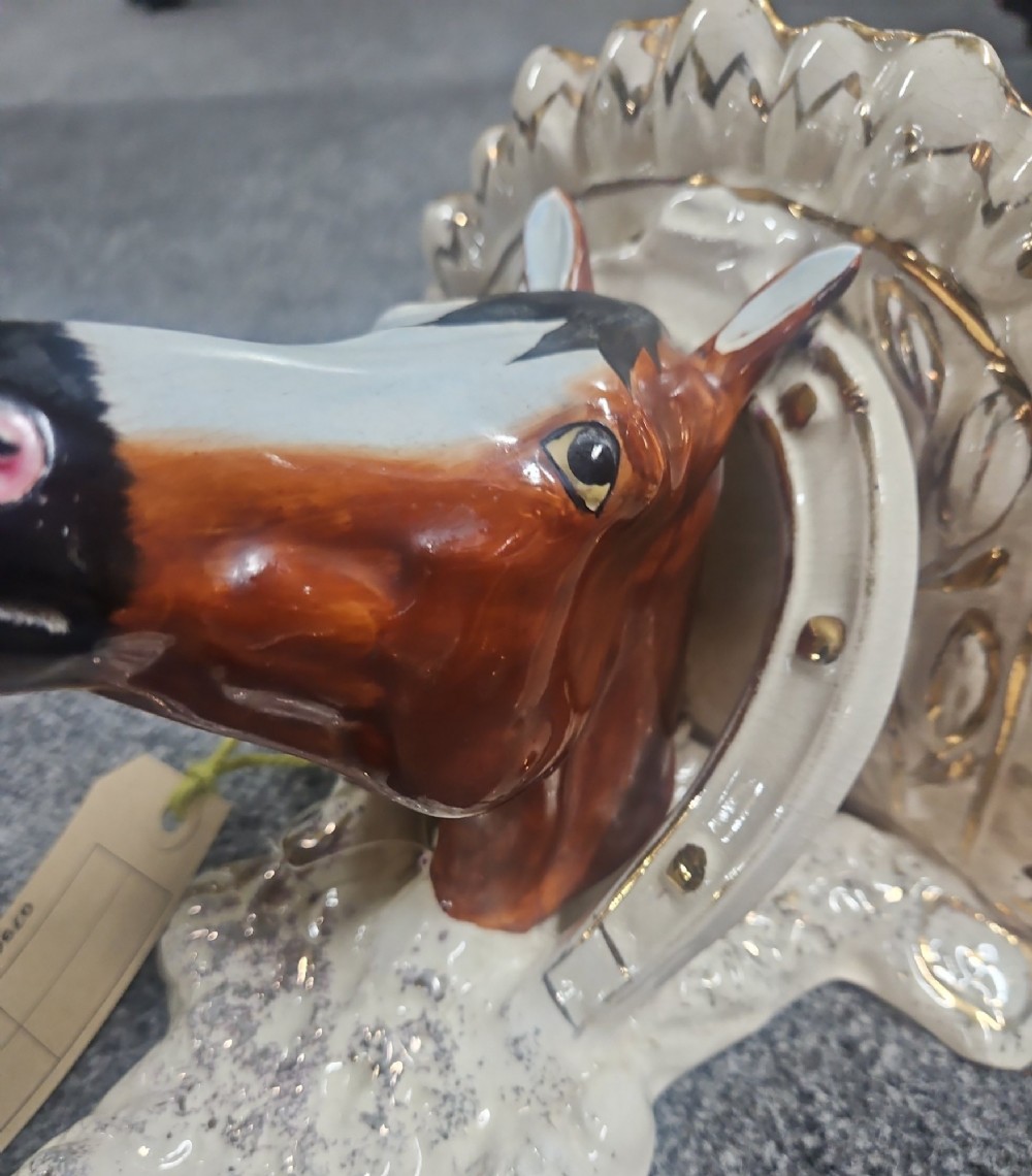 A pair of Victorian Staffordshire earthenware wall brackets featuring moulded horse heads framed by horseshoes with gilded decorative borders. View IX