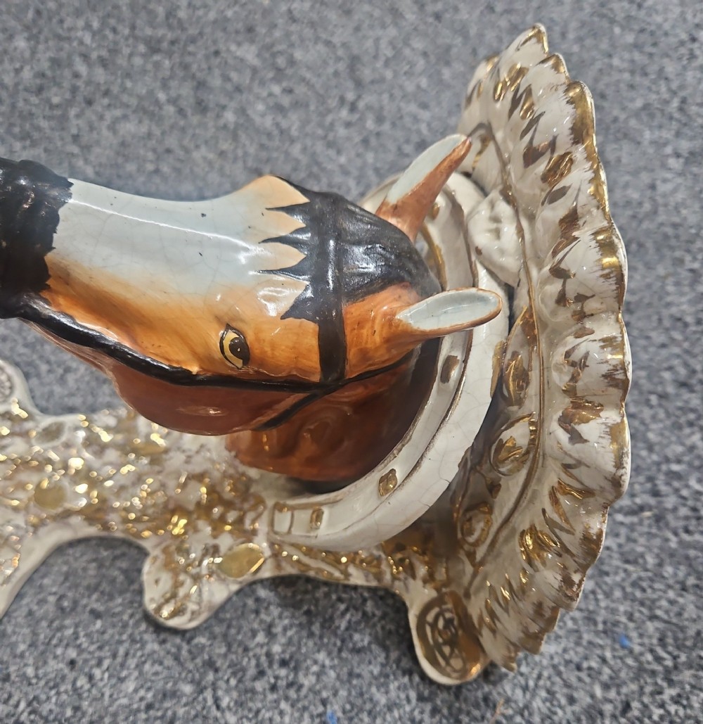 A pair of Victorian Staffordshire earthenware wall brackets featuring moulded horse heads framed by horseshoes with gilded decorative borders. View XII