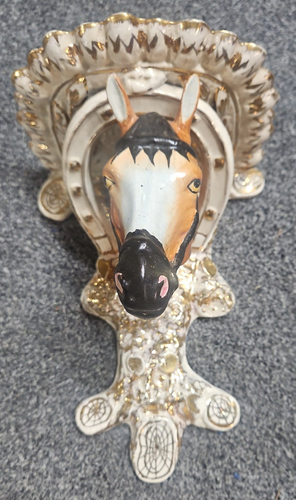 A pair of Victorian Staffordshire earthenware wall brackets featuring moulded horse heads framed by horseshoes with gilded decorative borders. View XIII