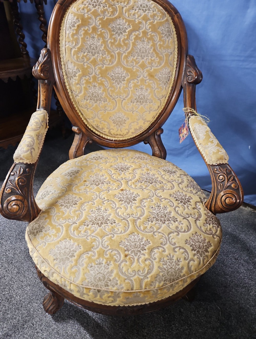 A Victorian walnut salon armchair with a carved wood frame, oval padded backrest, and yellow damask upholstered seat and armrests. View II
