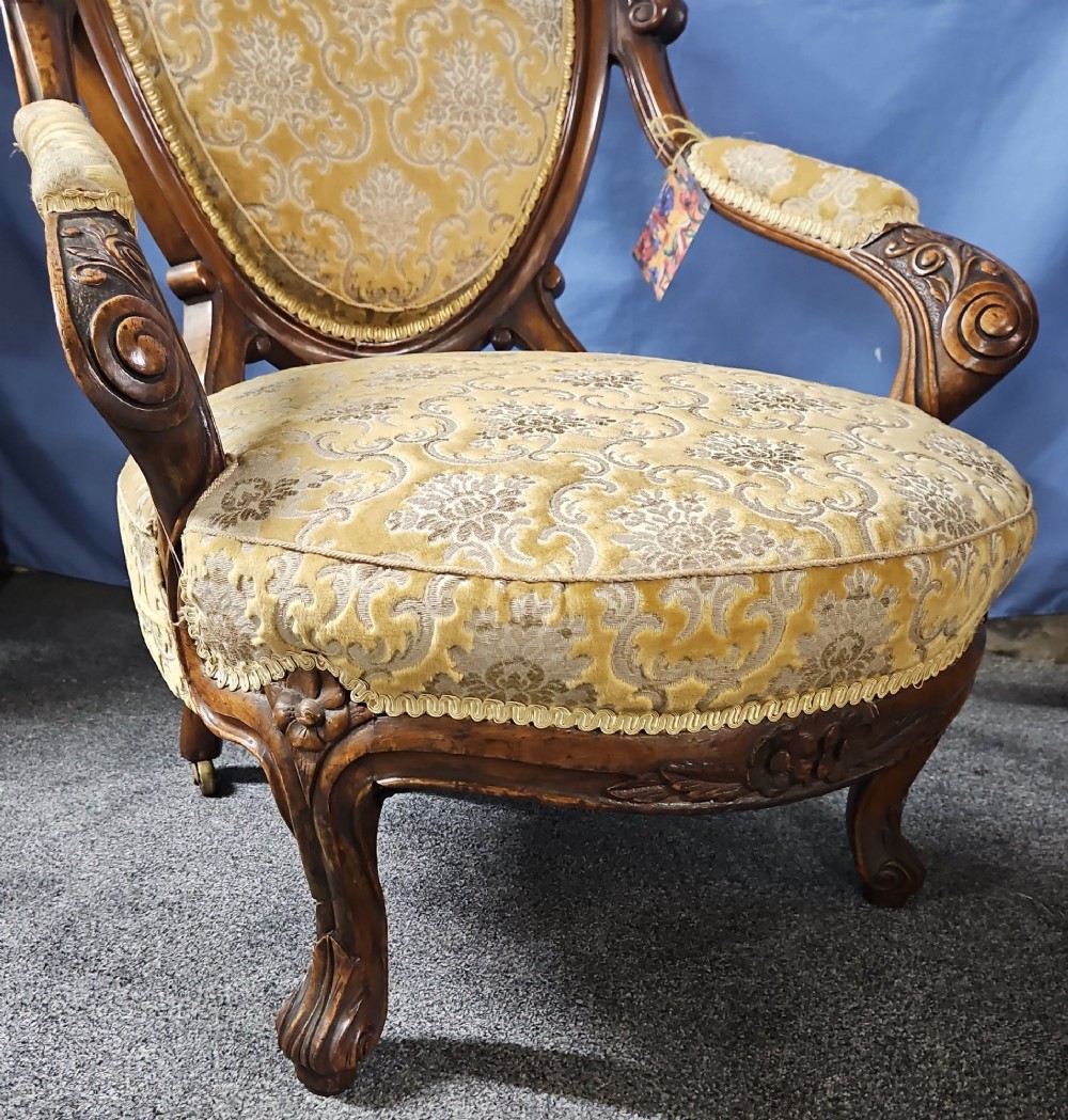 A Victorian walnut salon armchair with a carved wood frame, oval padded backrest, and yellow damask upholstered seat and armrests. View VIII