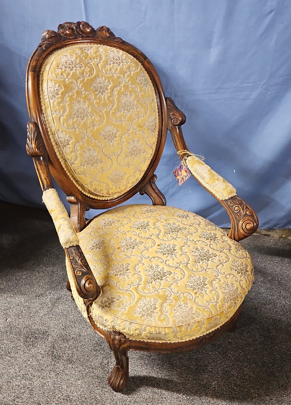 A Victorian walnut salon armchair with a carved wood frame, oval padded backrest, and yellow damask upholstered seat and armrests. View IX