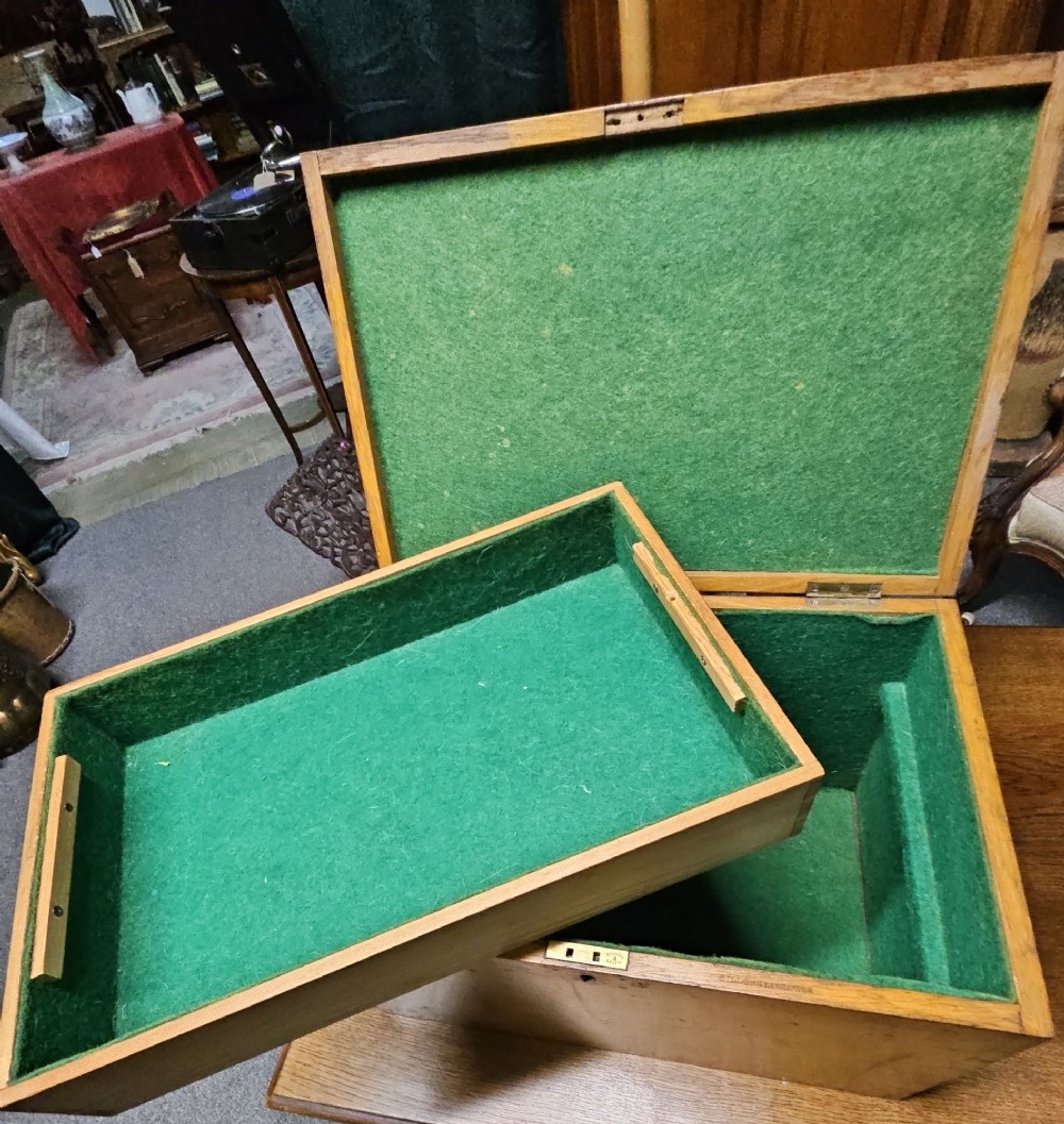 A rectangular light wooden antique storage box featuring visible dovetail corner joints and a central brass keyhole. View IV