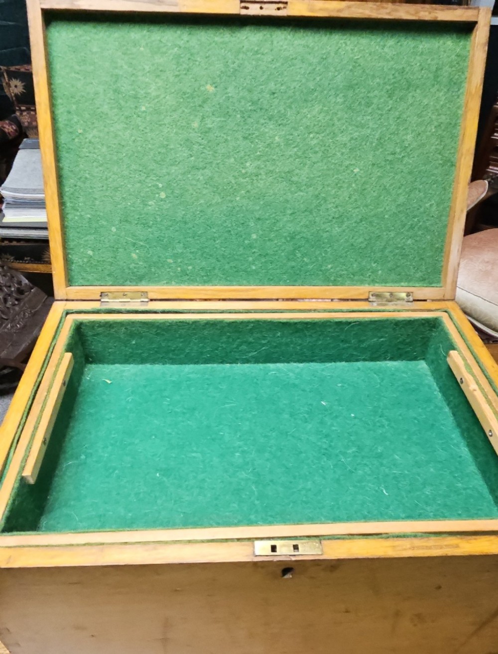 A rectangular light wooden antique storage box featuring visible dovetail corner joints and a central brass keyhole. View V