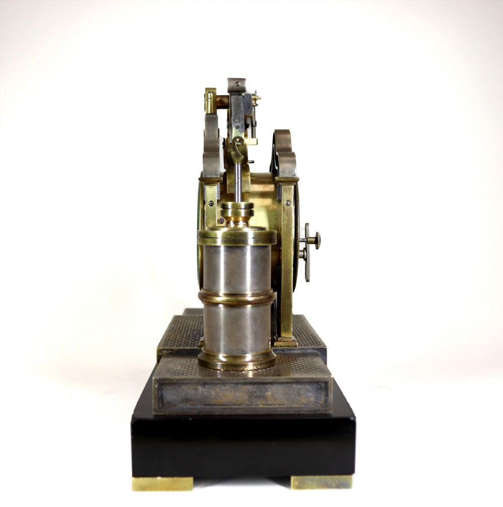 An industrial French automaton clock designed in the shape of a steam beam engine with brass and dark bronze components set on a black slate plinth. View III