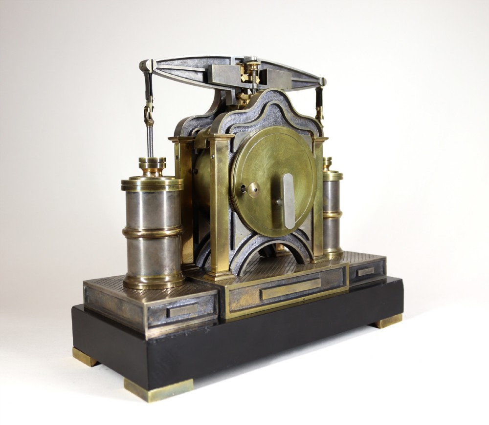 An industrial French automaton clock designed in the shape of a steam beam engine with brass and dark bronze components set on a black slate plinth. View V