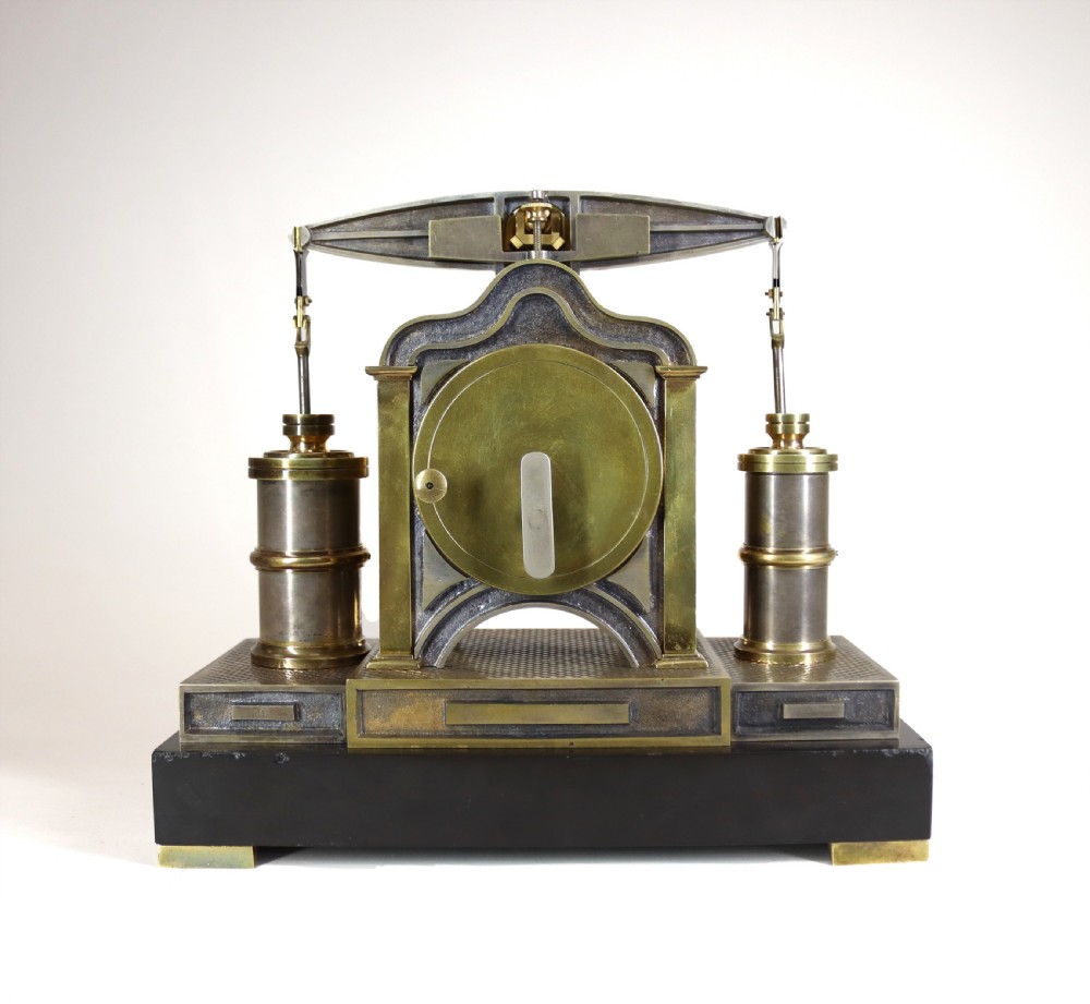 An industrial French automaton clock designed in the shape of a steam beam engine with brass and dark bronze components set on a black slate plinth. View VI