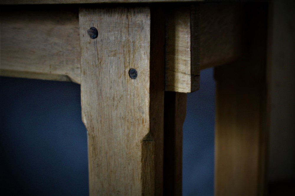 A pair of matching natural oak console tables in the Arts and Crafts style featuring straight rectangular tops, square legs, and Y-shaped lower stretchers. View III