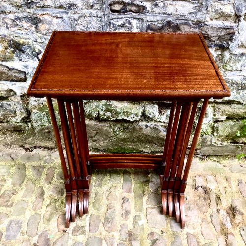 AN EDWARDIAN MAHOGANY NEST OF FOUR TABLES - ADDITIONAL PHOTO 1