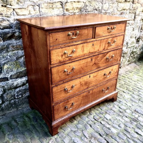 A GEORGE III CHERRY WOOD CHEST OF DRAWERS - ADDITIONAL PHOTO 1