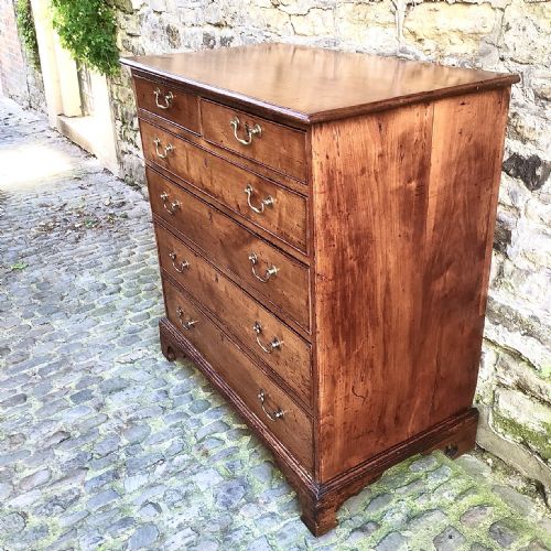 A GEORGE III CHERRY WOOD CHEST OF DRAWERS - ADDITIONAL PHOTO 4
