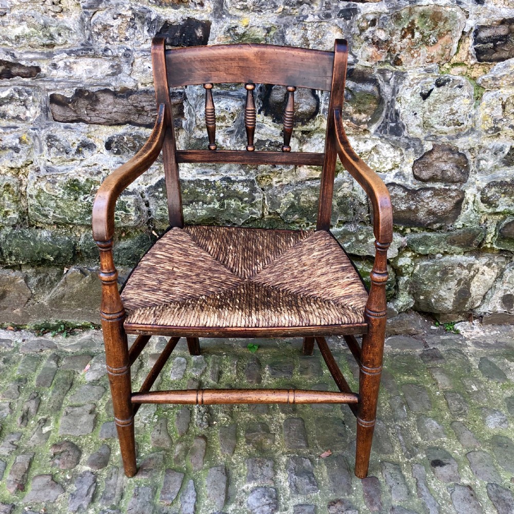 An early 19th century country elbow chair 