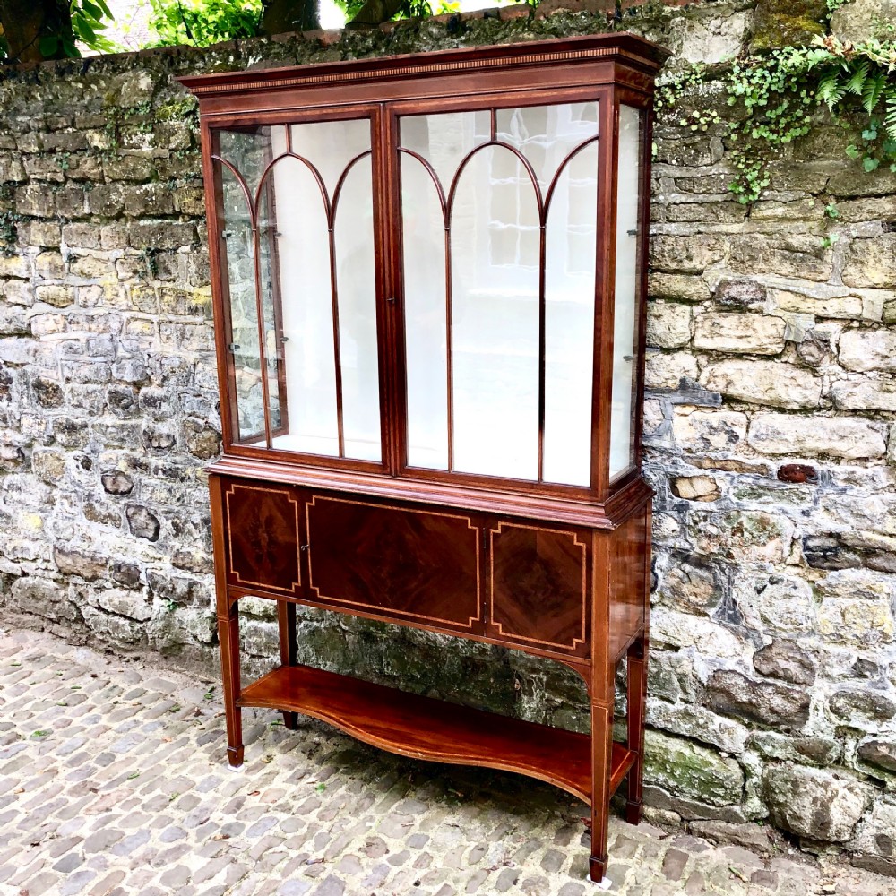 An Edwardian mahogany display cabinet on stand by Maples.  View II