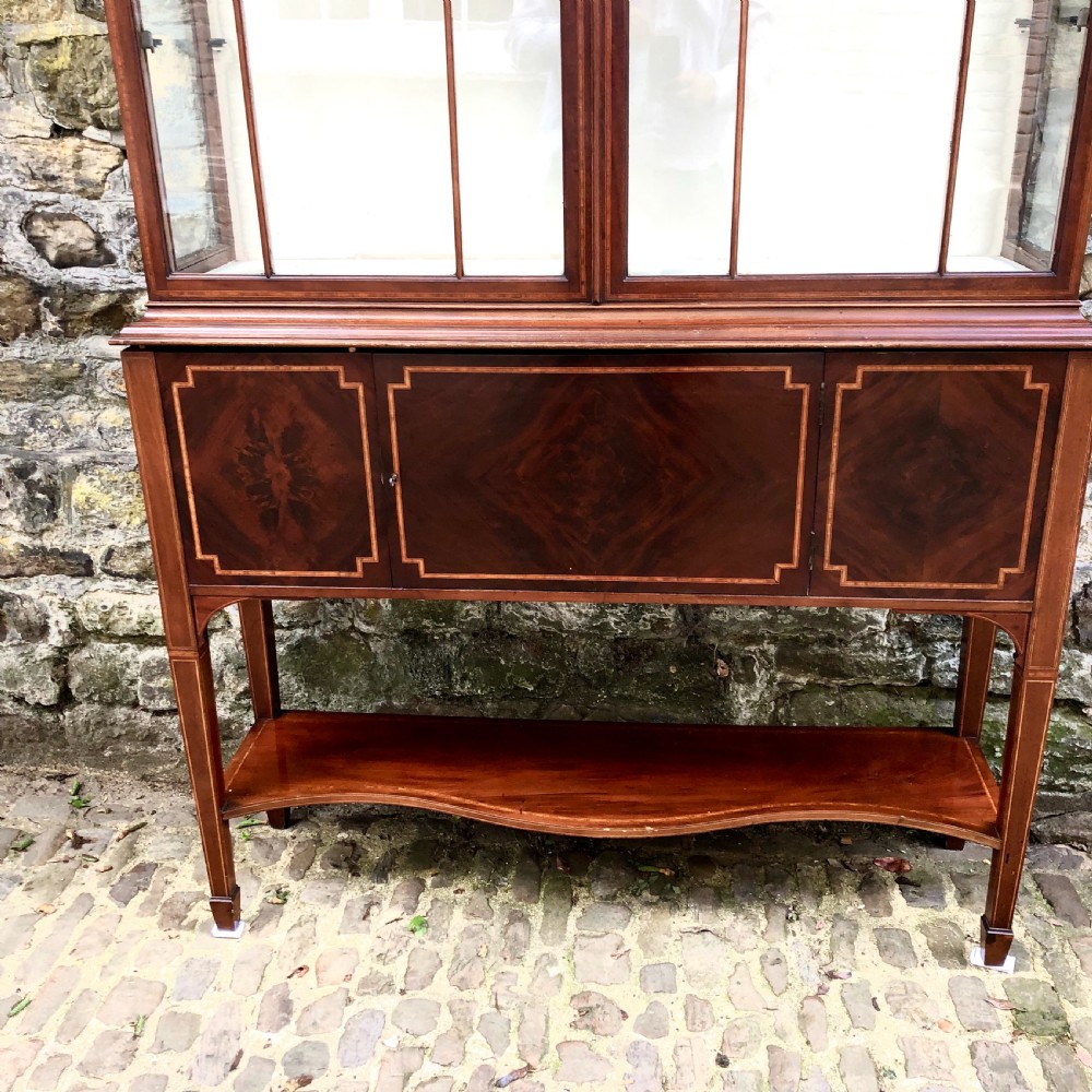 An Edwardian mahogany display cabinet on stand by Maples.  View VII