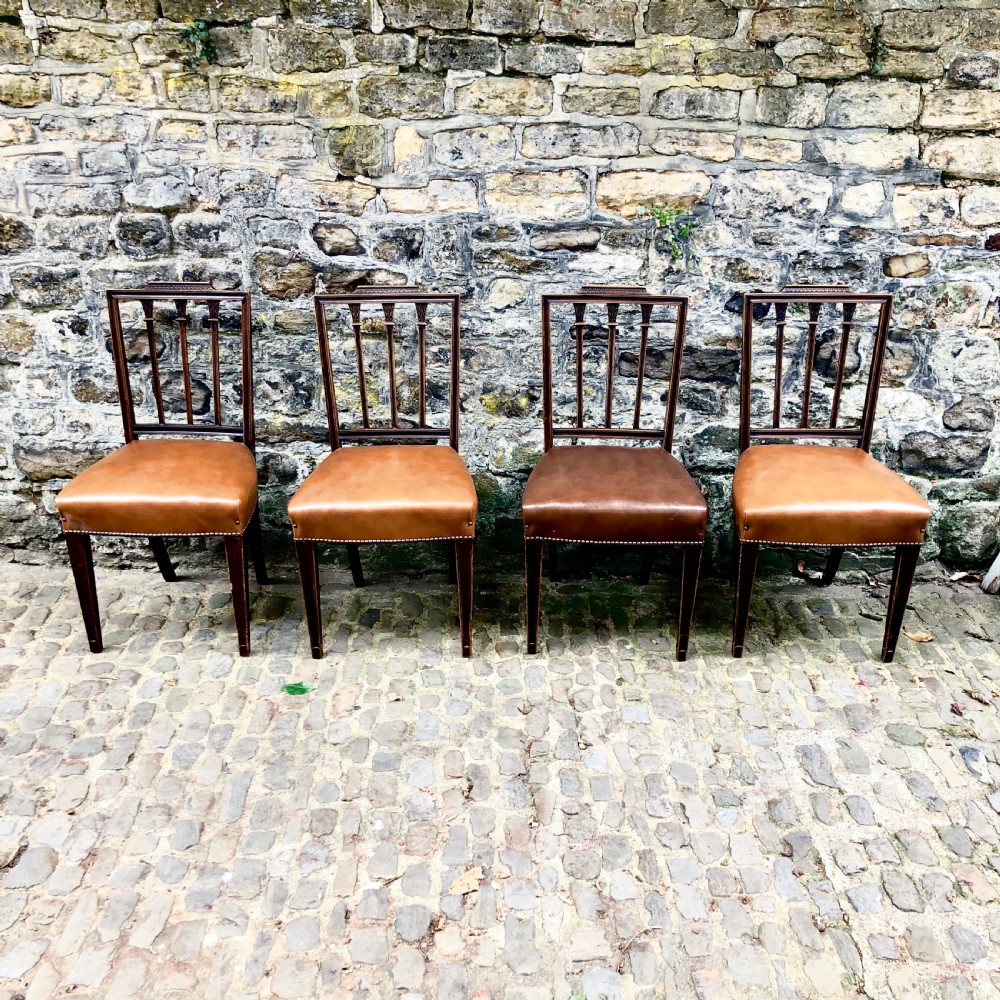 A set of four Sheraton Revival mahogany dining chairs 
