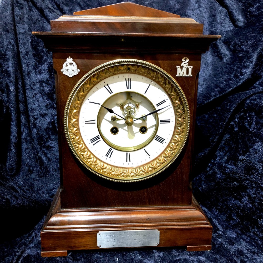 A late 19th century mahogany table clock with military interest. 