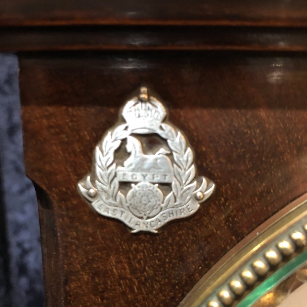 A late 19th century mahogany table clock with military interest.  View VII