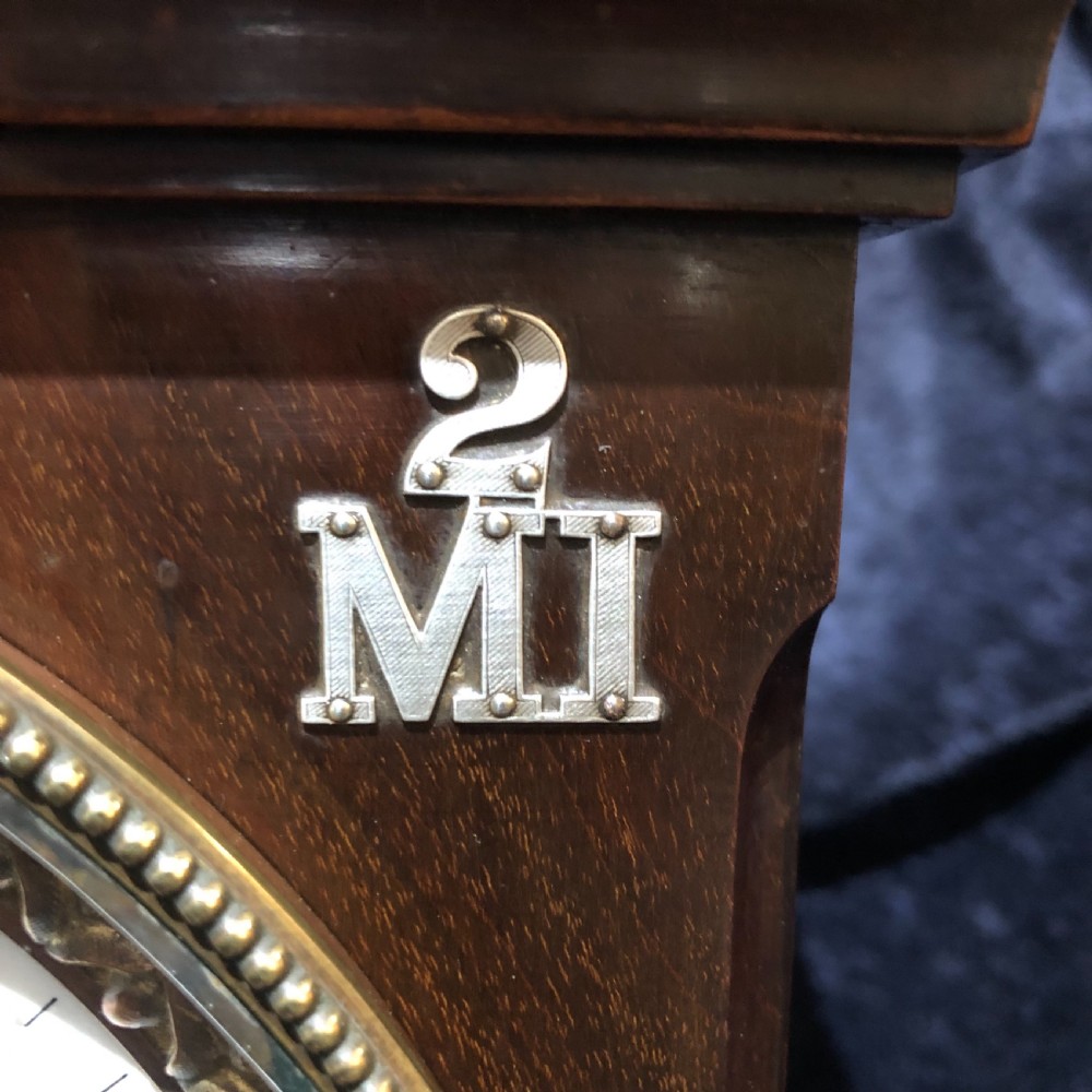 A late 19th century mahogany table clock with military interest.  View IX