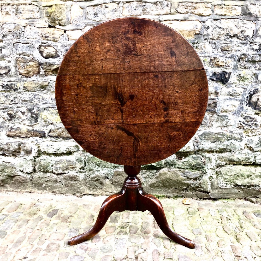 An early George III oak tripod table 