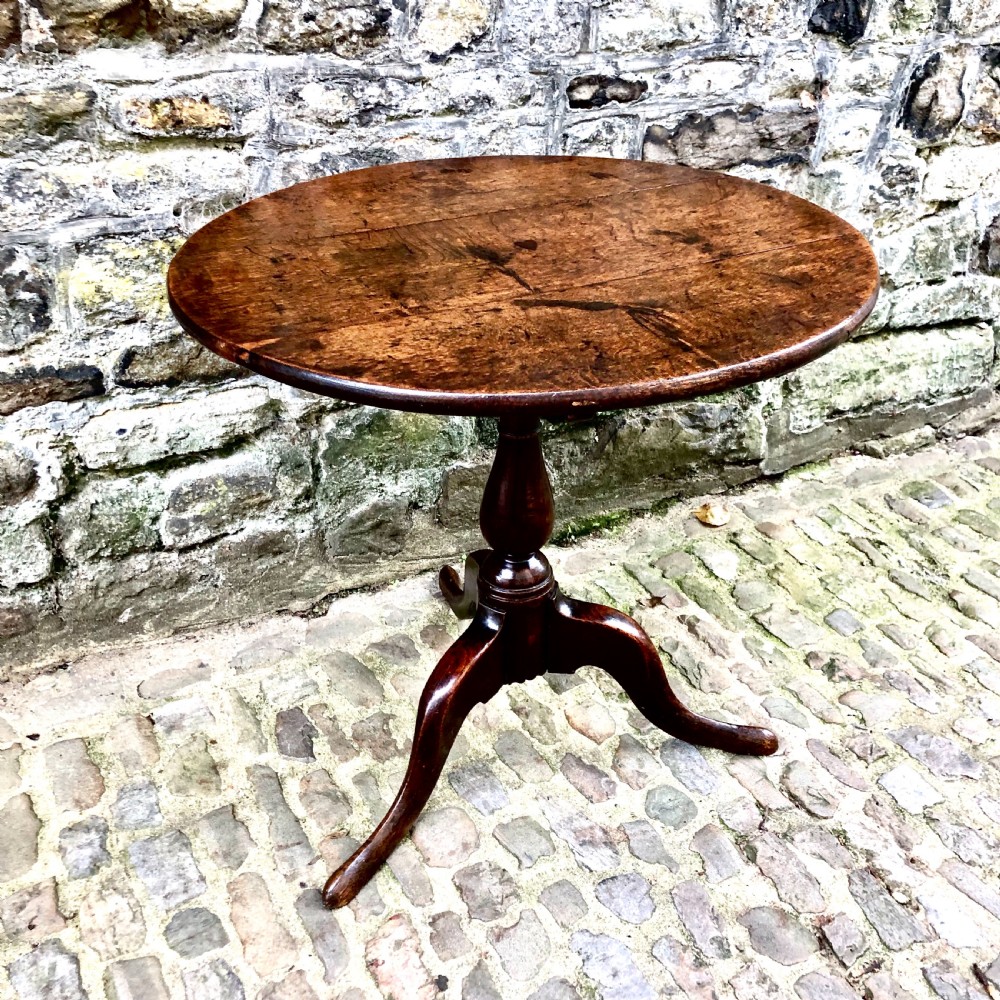 An early George III oak tripod table  View II