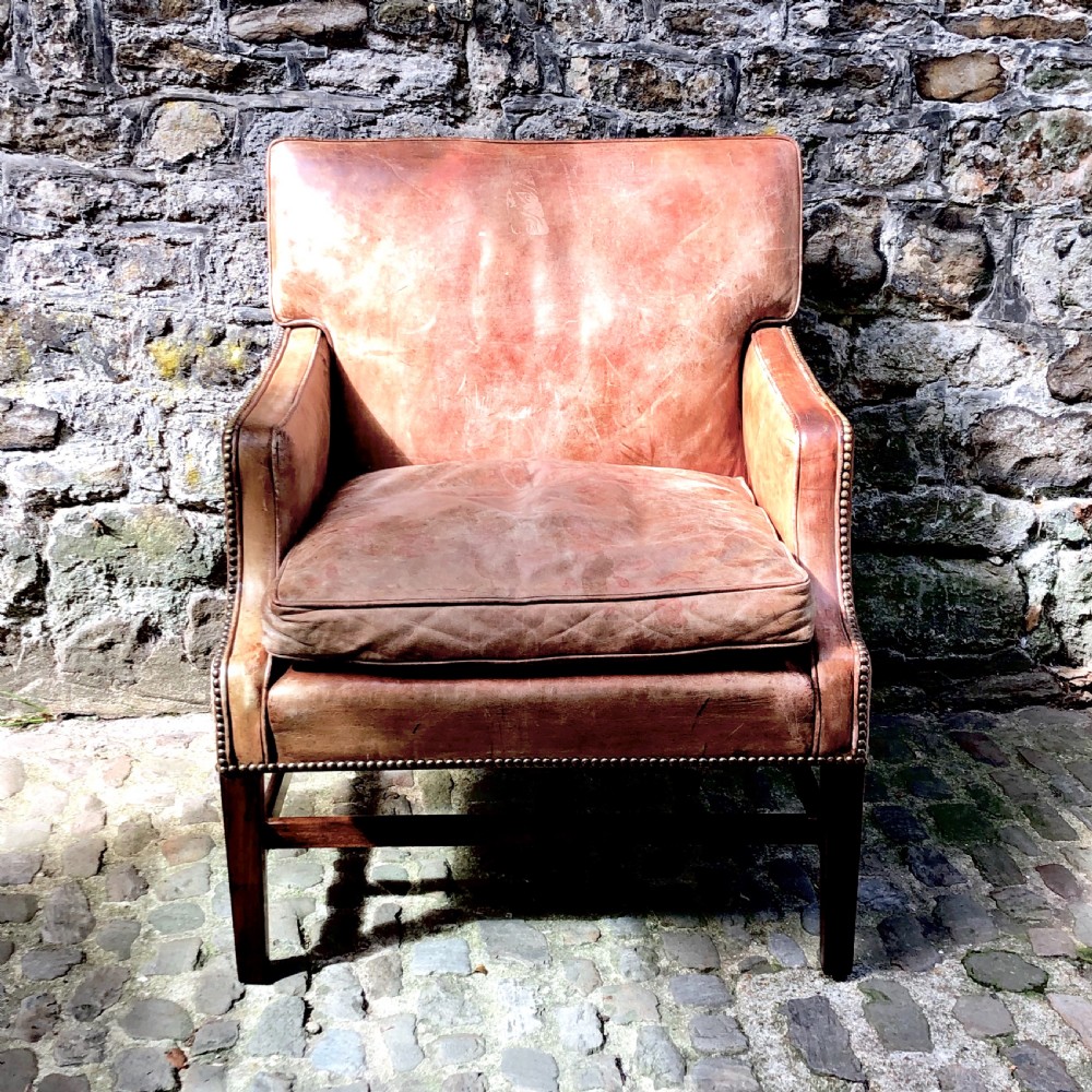 An Edwardian leather and mahogany armchair 