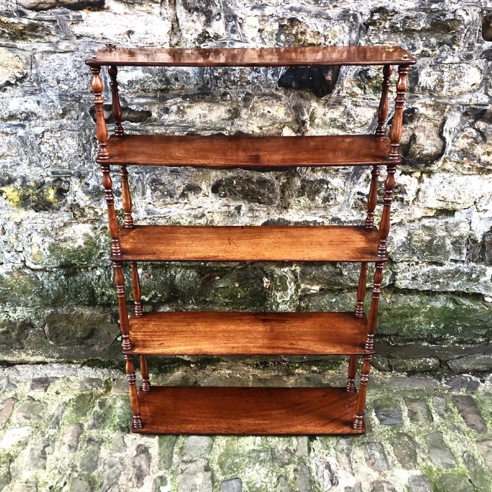 A George IV set of mahogany hanging shelves 