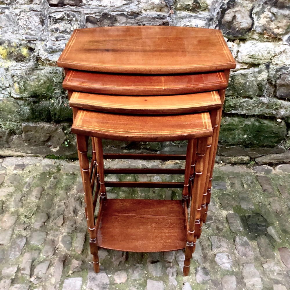 An Edwardian nest of four mahogany side tables 